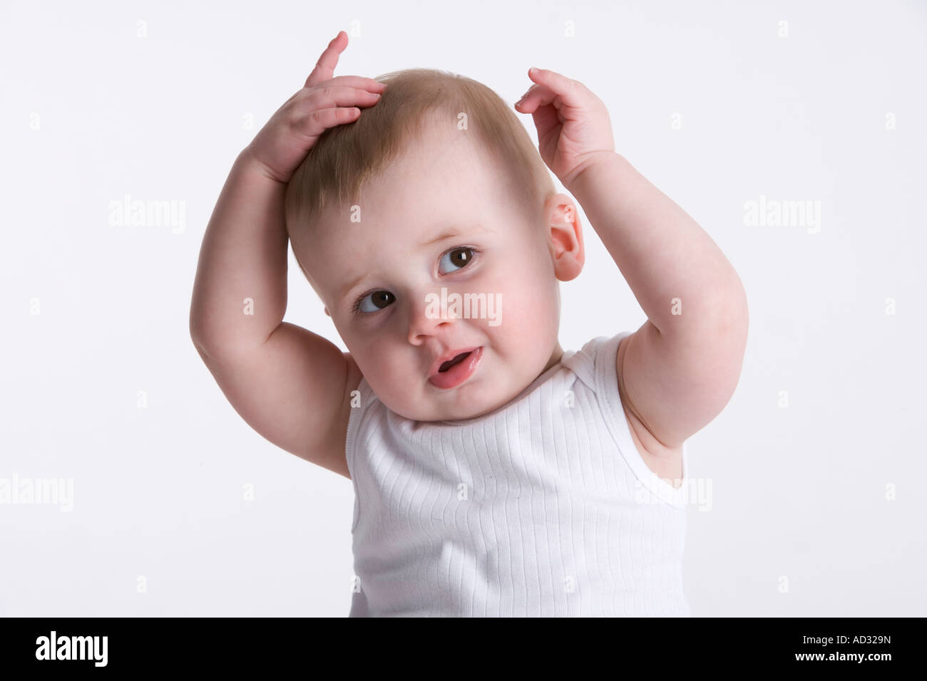 Little baby holding his hands on his head Stock Photo Alamy