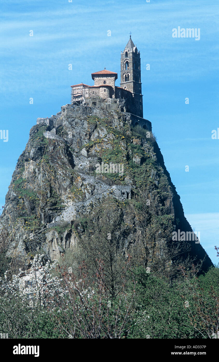 The pilgrimage chapel of St.Michel d'Aiguilhe on top of a volcanic rock pinnacle is a dramatic sight in France's Le-Puy-en-Velay Stock Photo