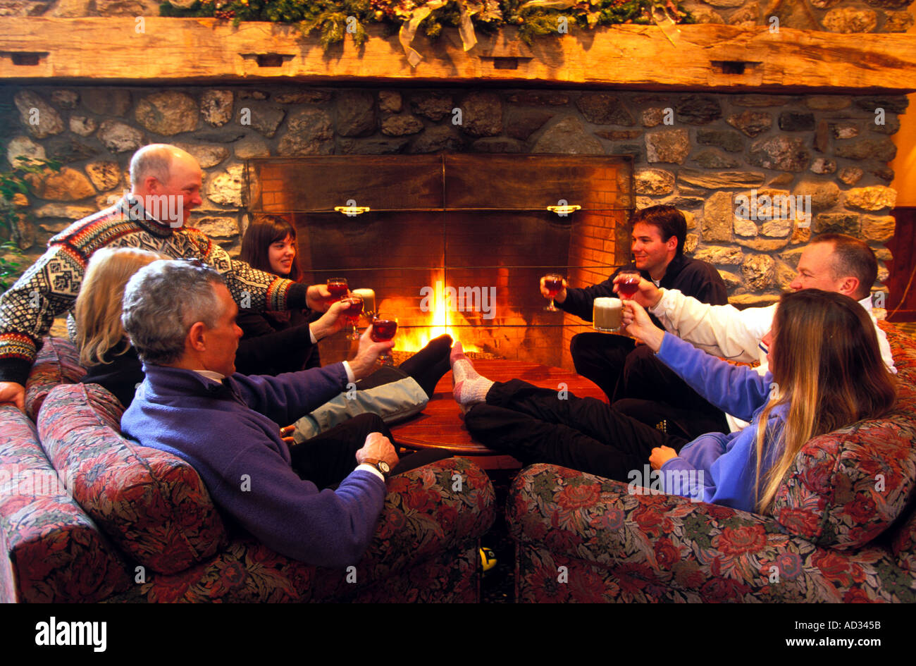 Group of friends relaxing in their chalet after a hard day on the slopes Stock Photo