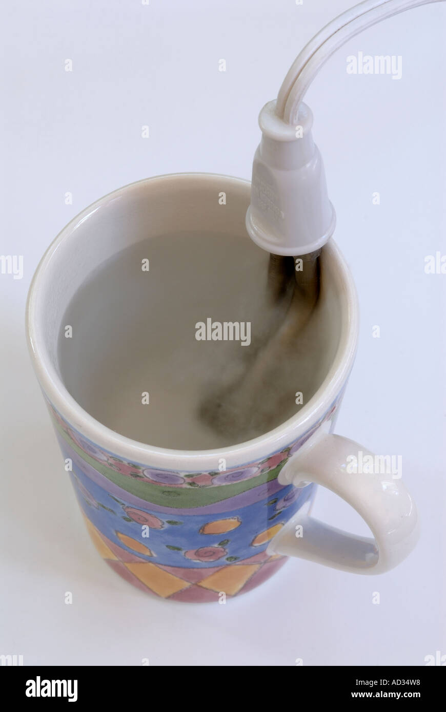 Immersion heater in mug with boiling water Stock Photo Alamy