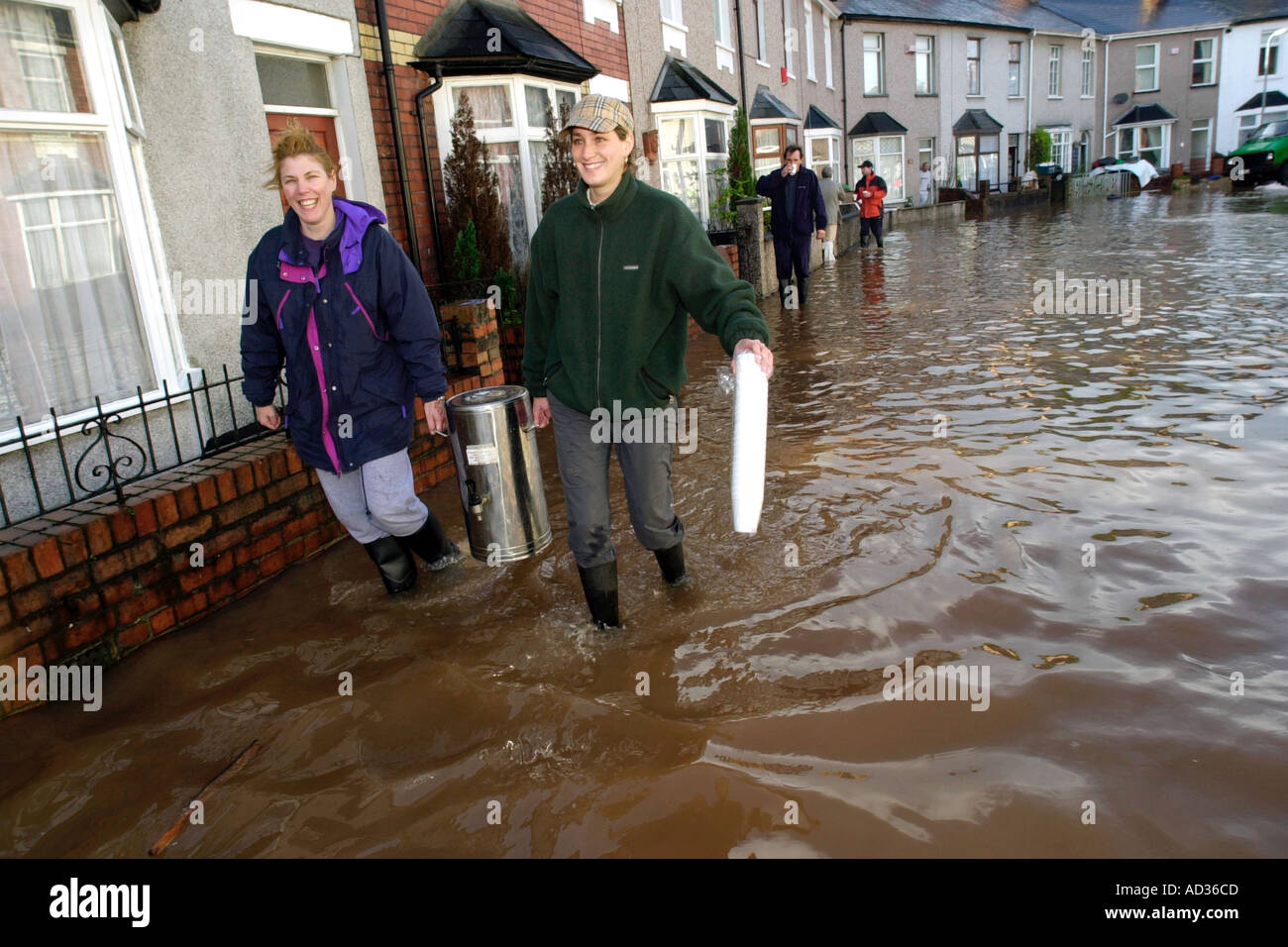 Volunteers take an urn of tea to householders whose homes were flooded after heavy rain in Newport Gwent South Wales UK GB Stock Photo