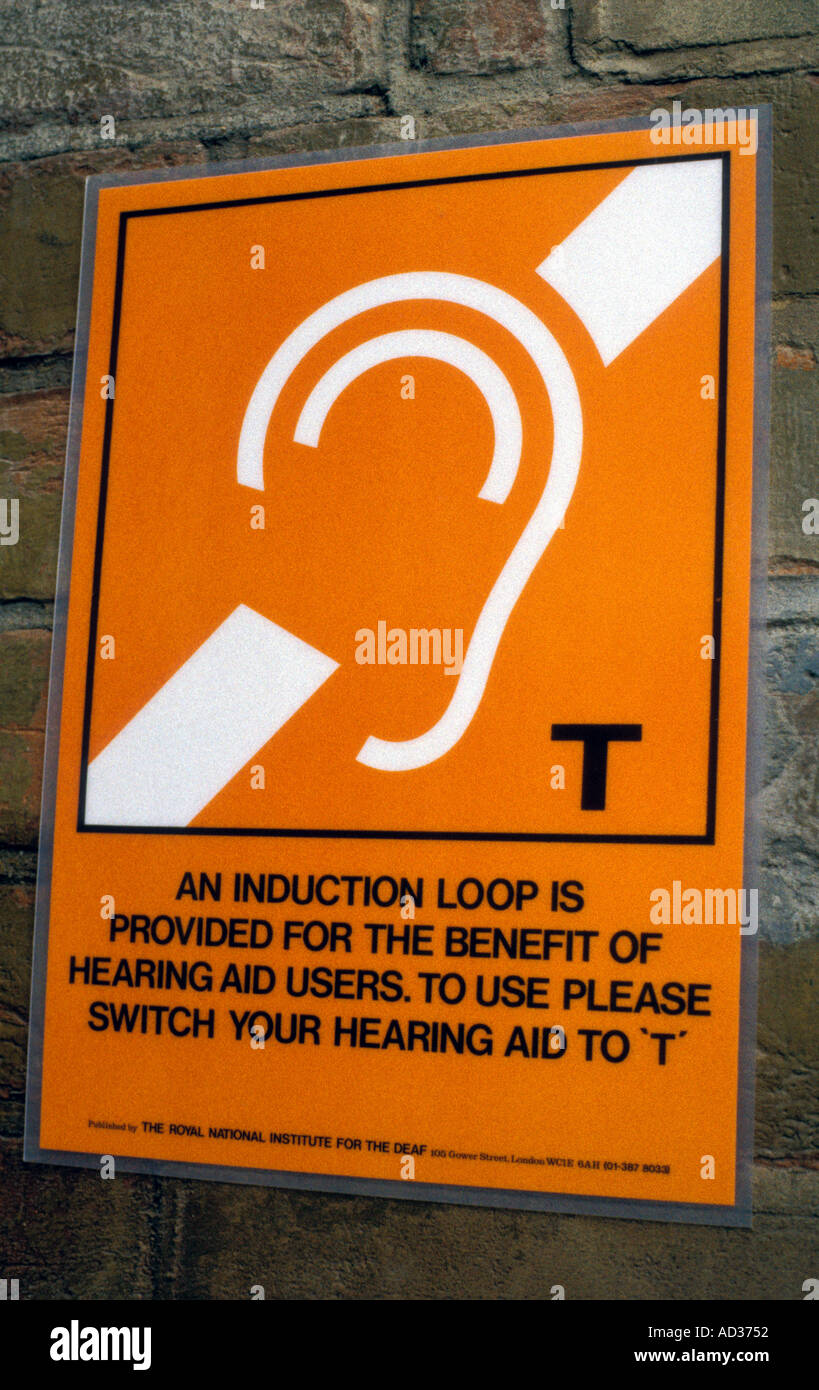 Sign announcing provision of induction loop for the benefit of hearing aid users. Stock Photo