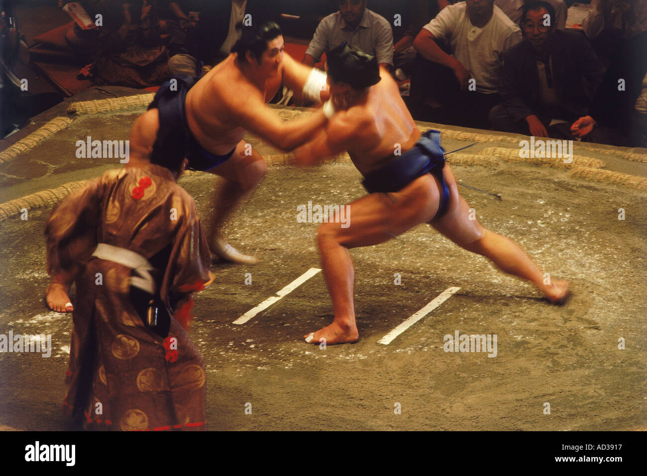 Sumo wrestlers wearing mawashi or loincloth fighting in circle called dohyo Stock Photo