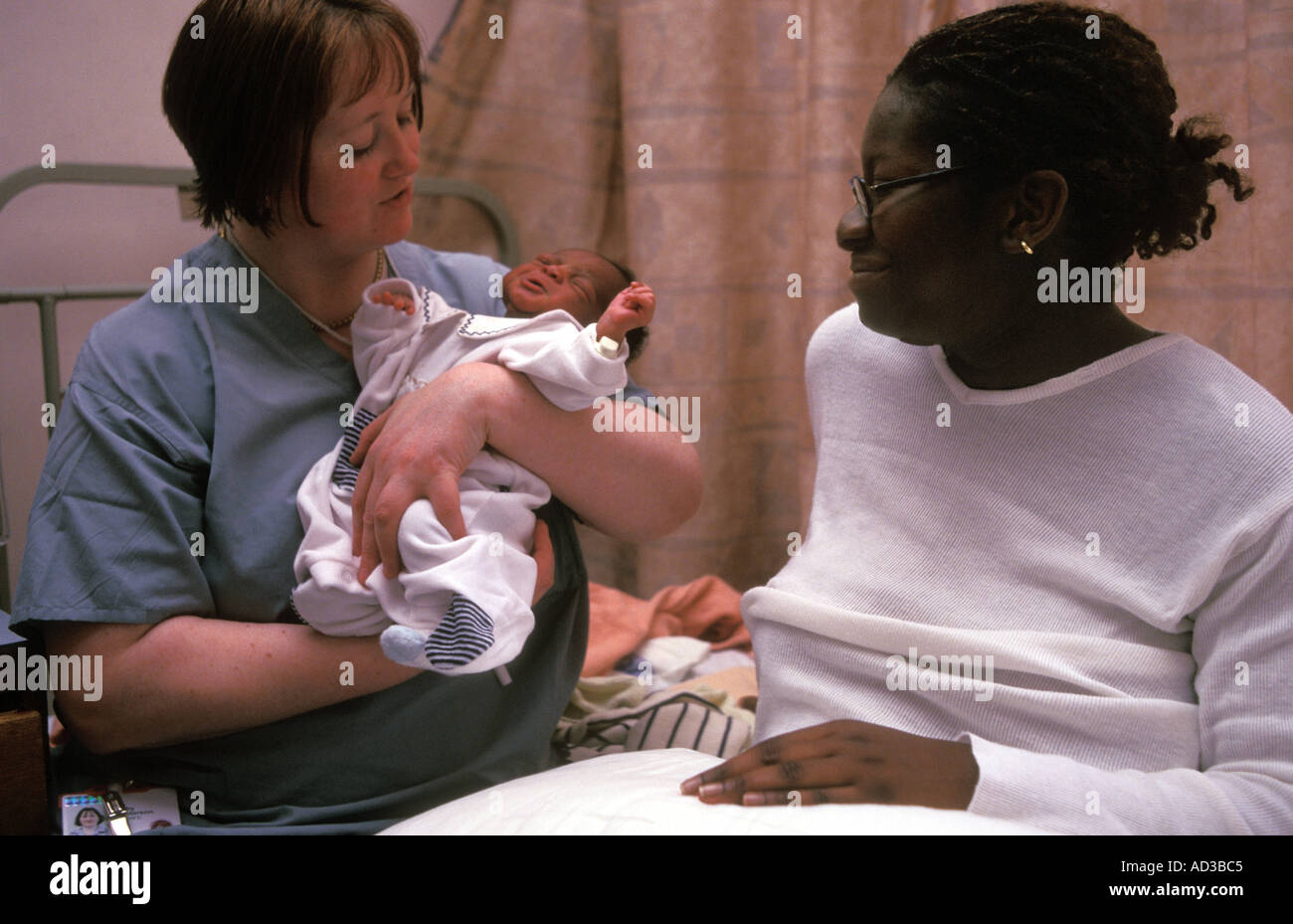 Midwife with mother and new born baby in Queen Charlotte Hospital London. Stock Photo