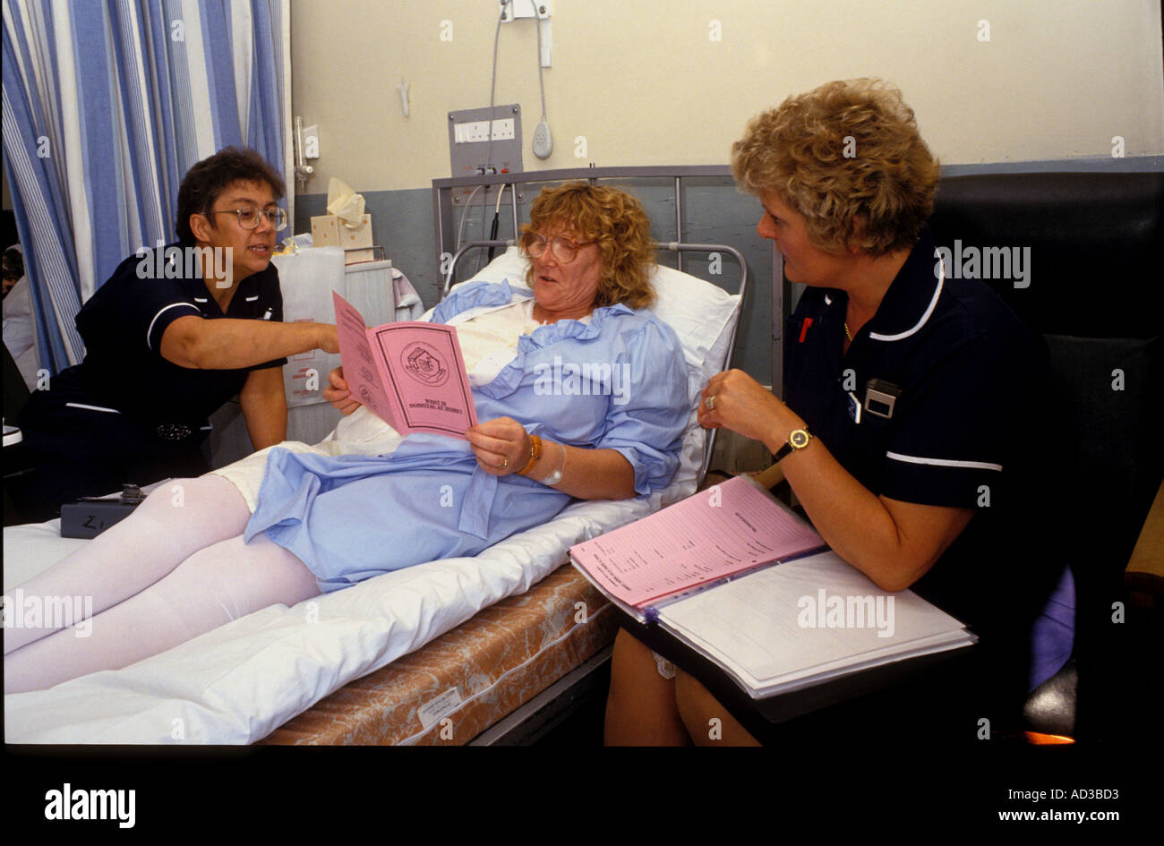 District nurses discussing after care with patient Stock Photo Alamy