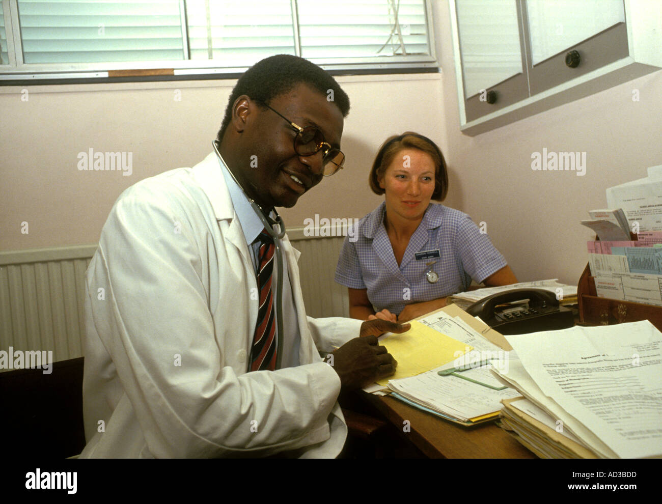 Doctor and nurse consulting with patient Stock Photo