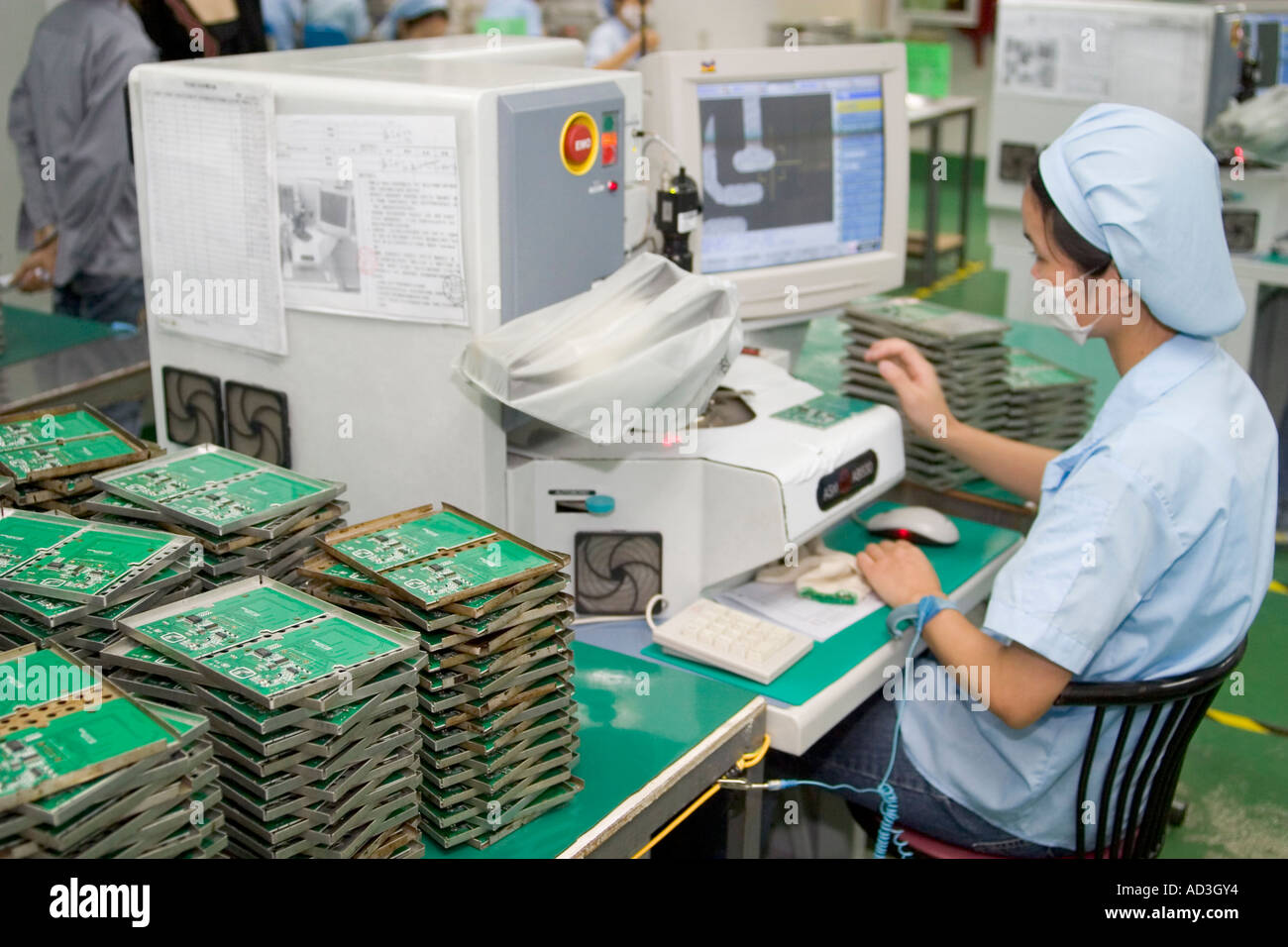 Chinese High Tech Factory workers working by hand with LCD display boards assembling components Stock Photo