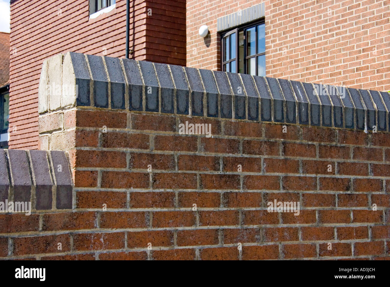 Soldier course of bricks used as decorative feature along the top of a wall and along the top of a house window Stock Photo