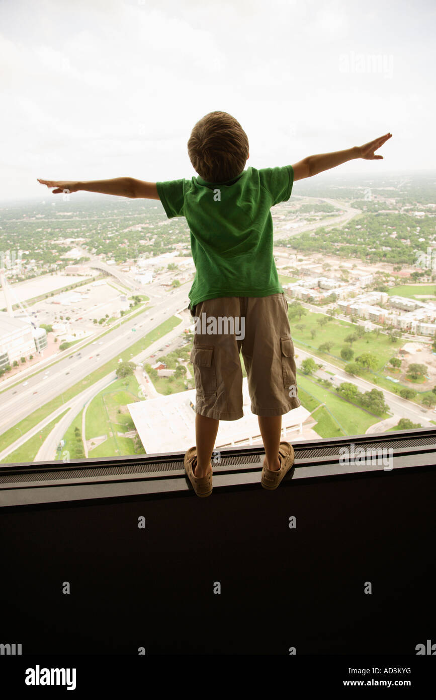 Young Caucasian boy standing on observation deck at Tower of the Americas in San Antonio Texas Stock Photo