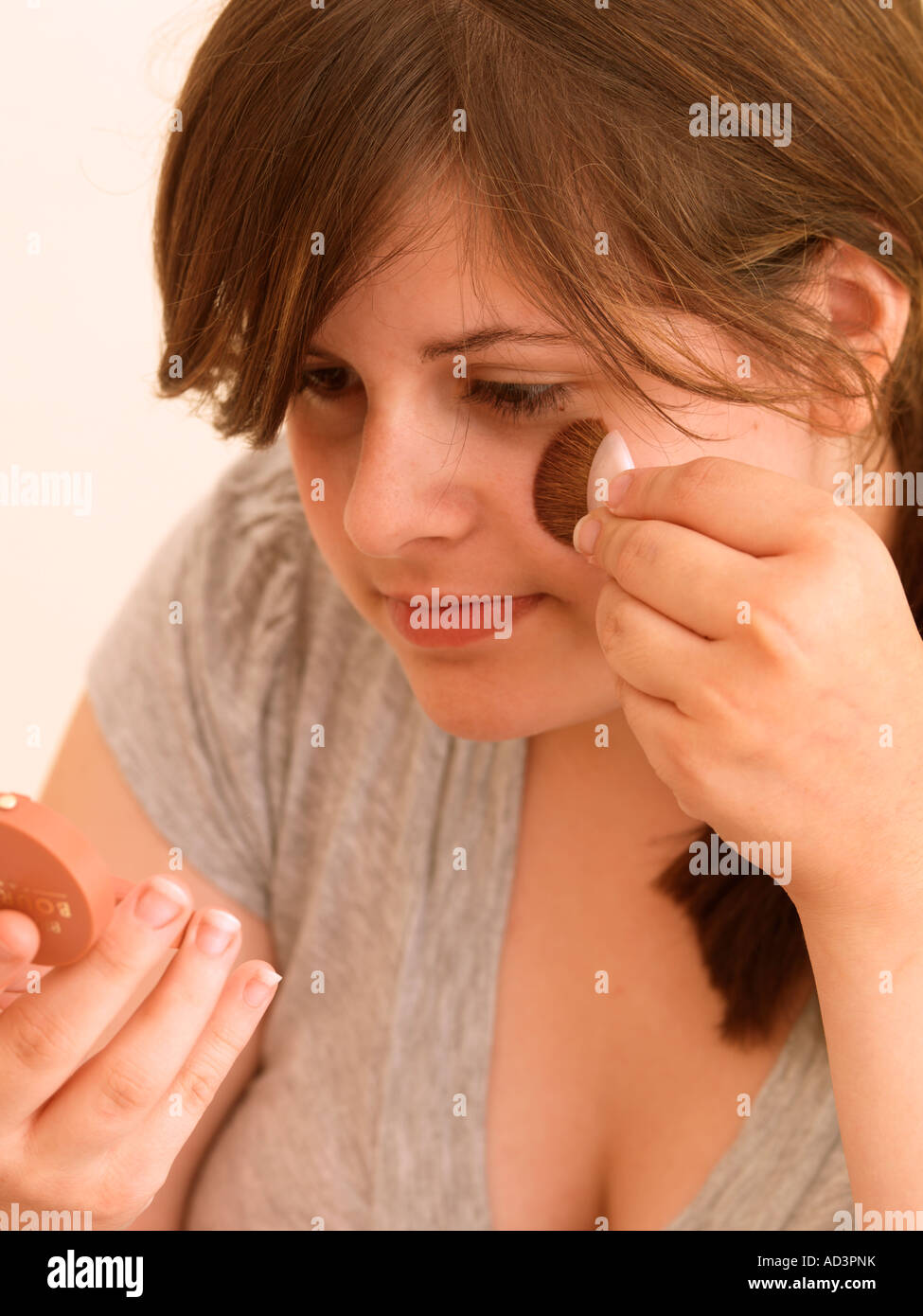 Teenage Girl Applying Blusher Stock Photo