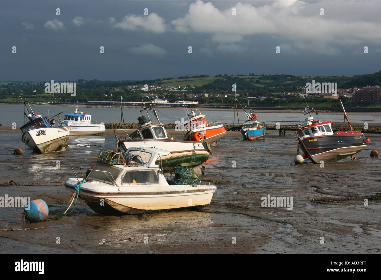 Small boats on beach at low tide at RhosonSea harbour, North Wales