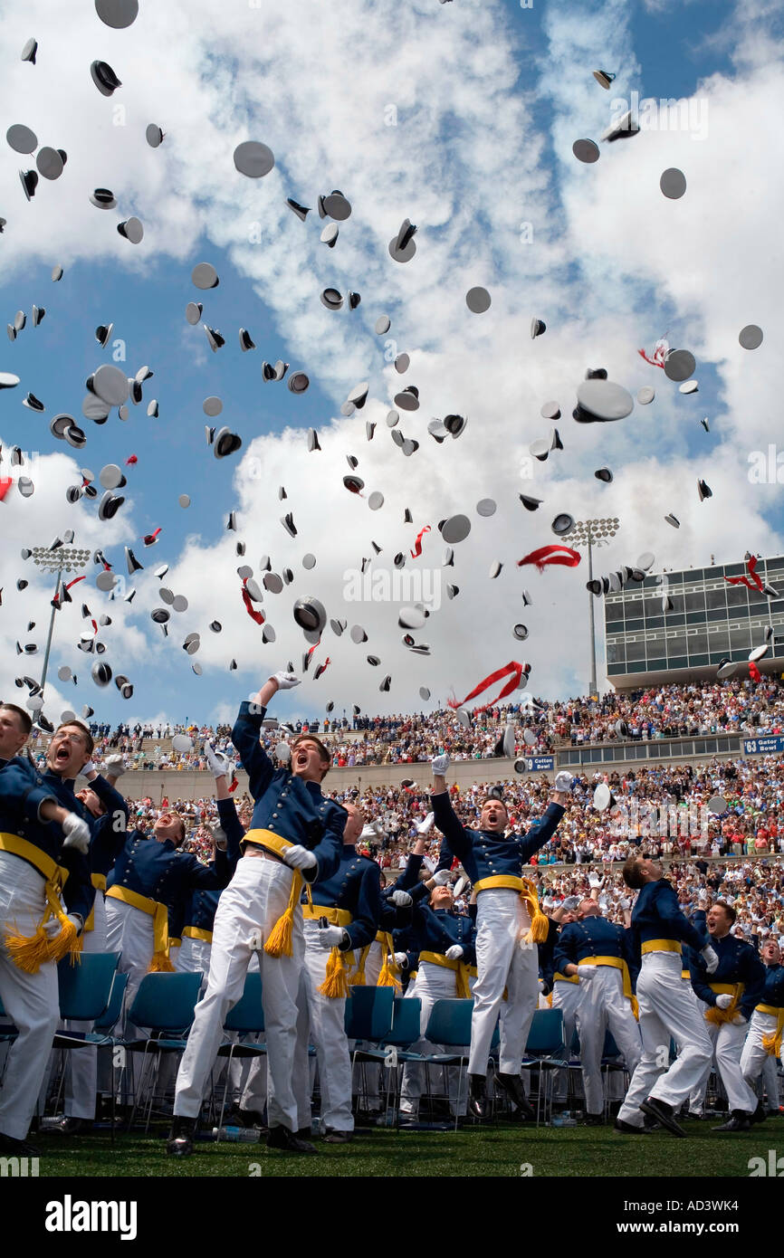 Newly commissioned U.S. Naval Officers celebrate by throwing their hats in the air. Stock Photo