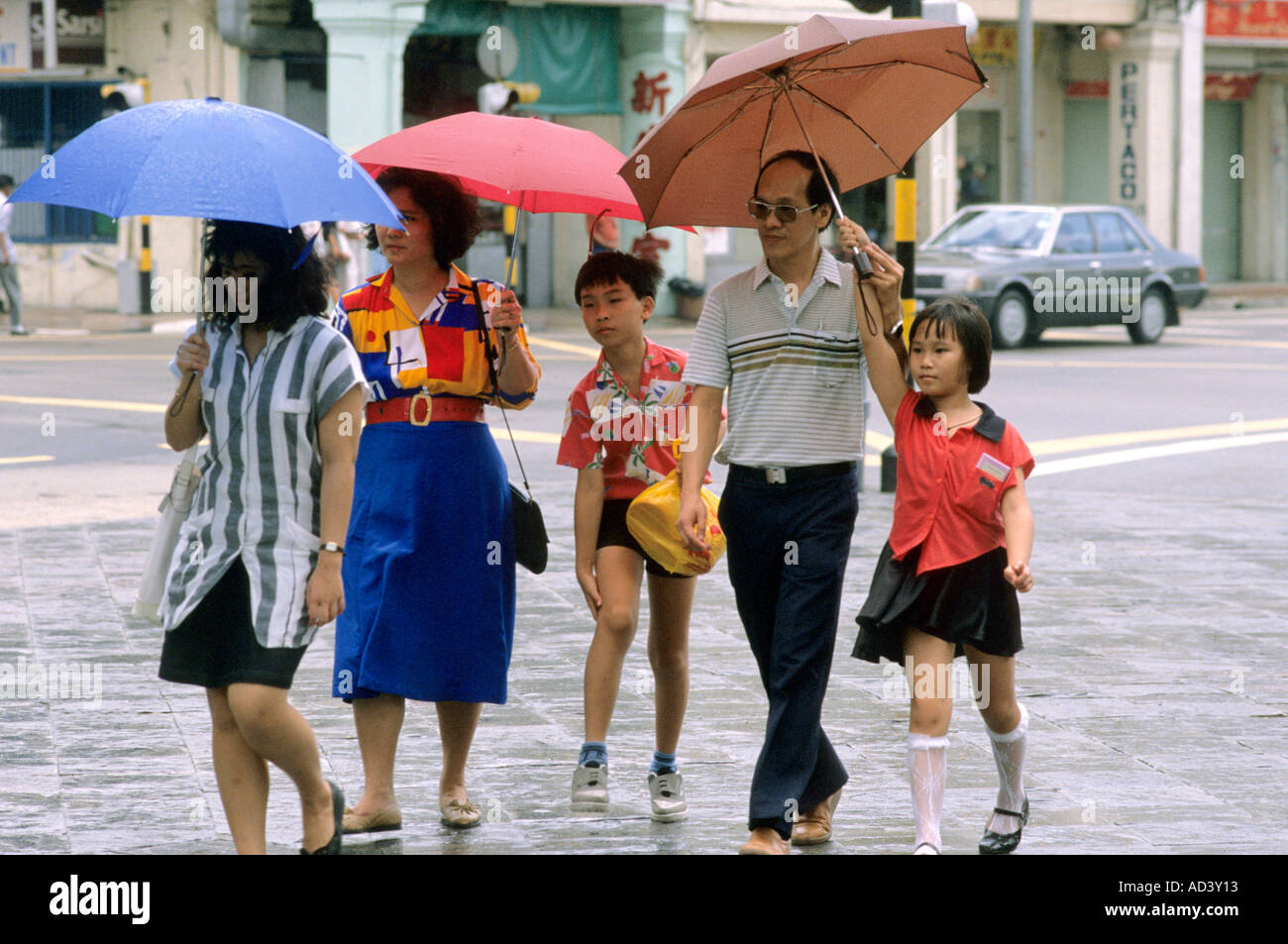 People in Singapore holding umbrellas in the rain Stock Photo - Alamy