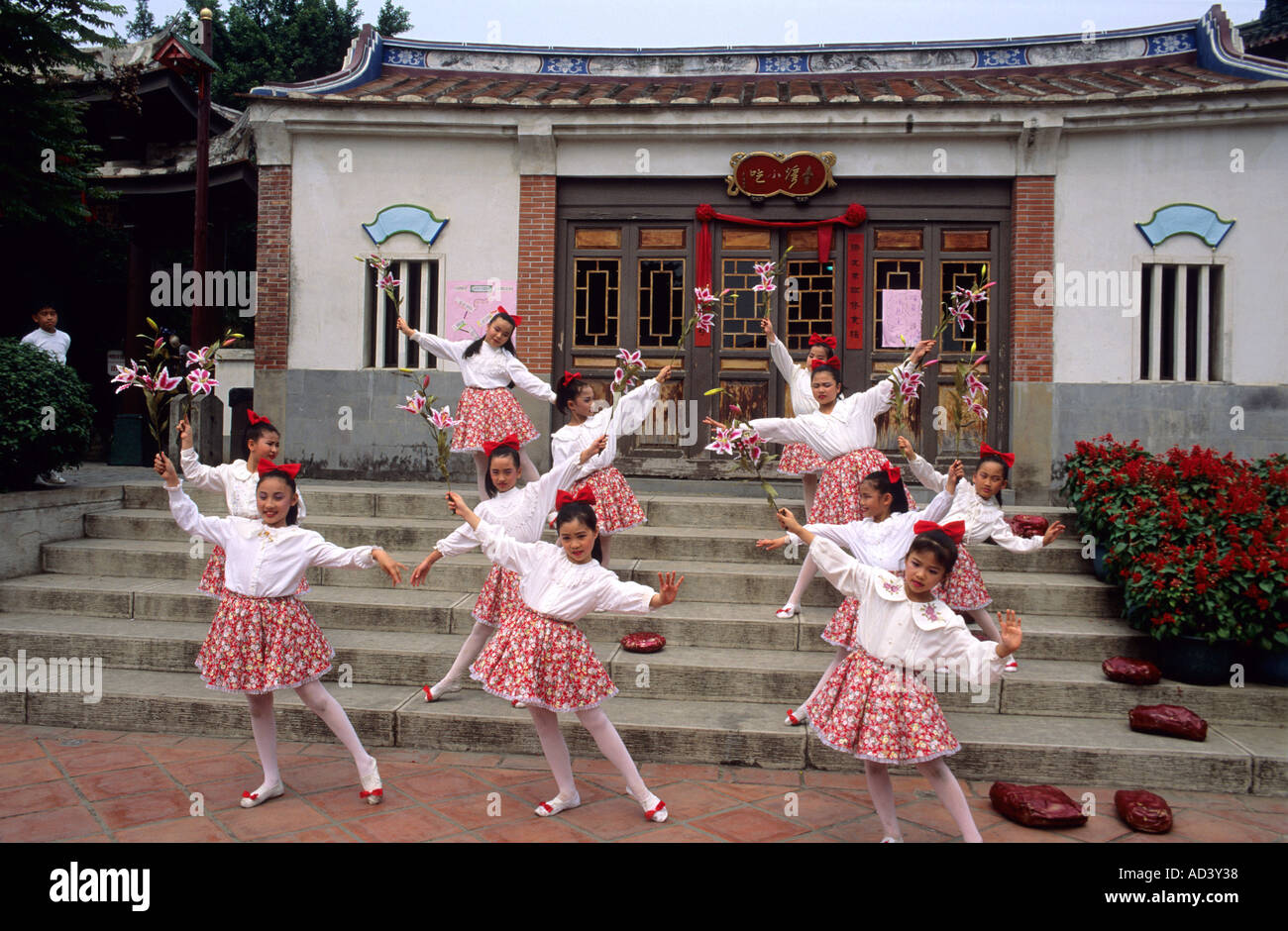 Girls dance with flowers at the Chinese children festival in Taiwan ...