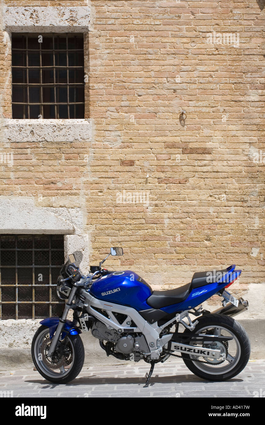 Italian blue Suzuki Motor SV650 bike parked in medieval hill town of San Gimignano Tuscany Italy, Europe, EU Stock Photo