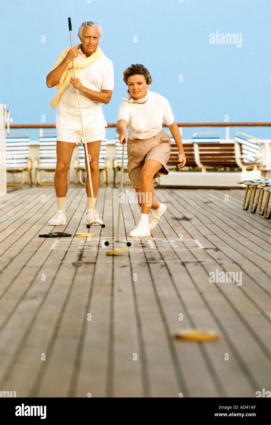 Senior couple playing shuffleboard on cruise ship Stock Photo Alamy