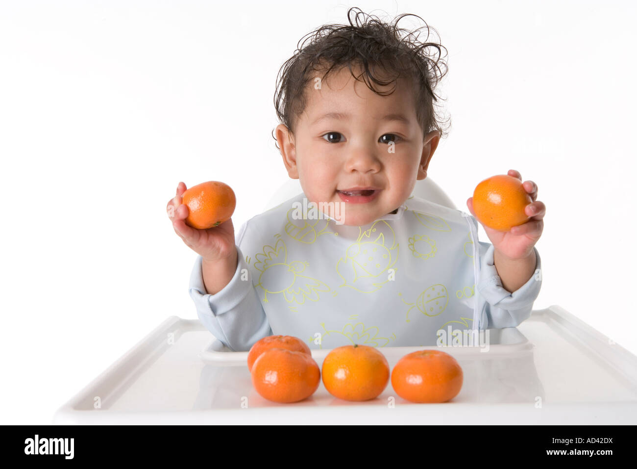 Little baby boy with mandarins Stock Photo Alamy