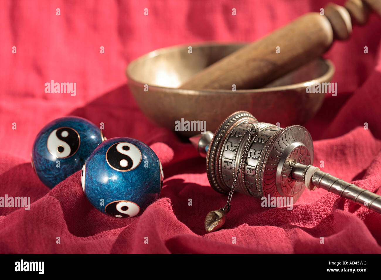 Yin-yang balls, prayer wheel and singing bowl Stock Photo