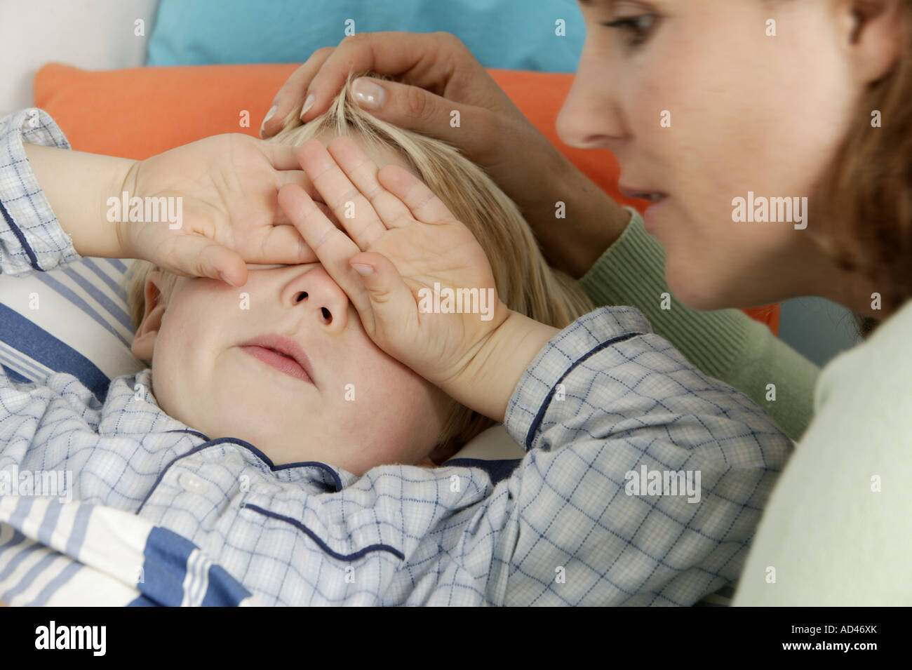 Mother brings her son to bed Stock Photo