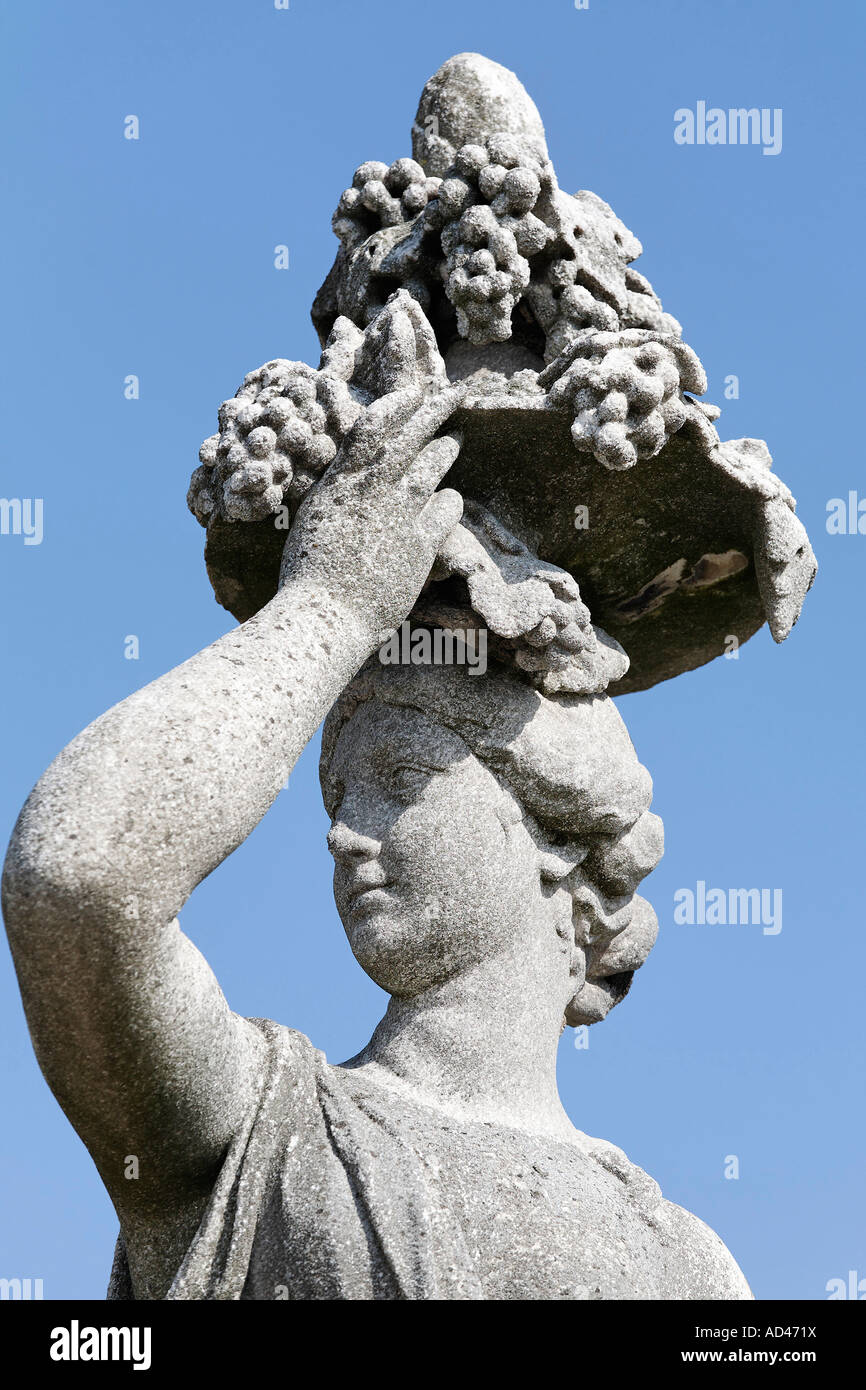 Woman carrying a tray with grapes on her head, sculpture at castle