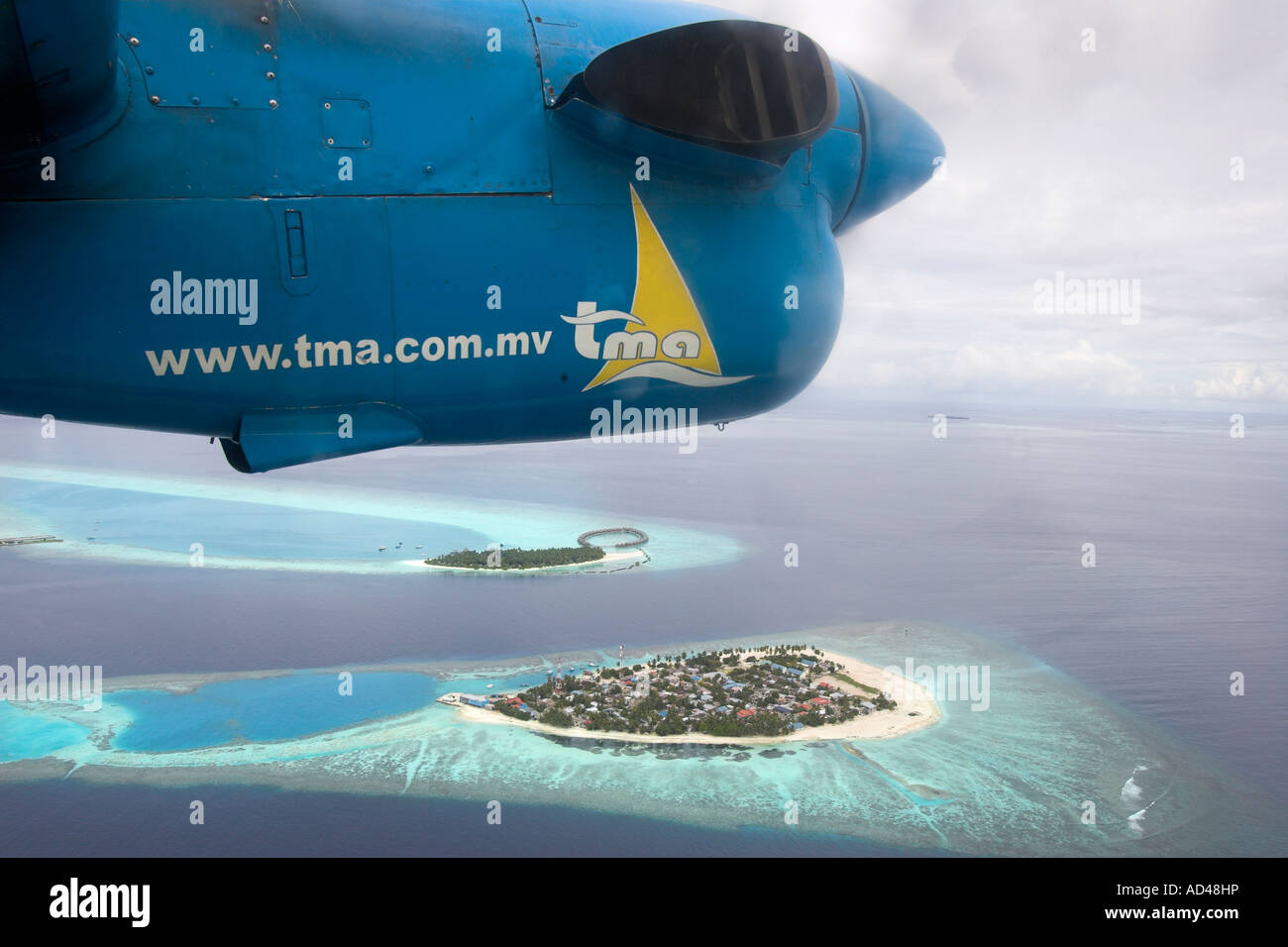 Aeroplane flies over the reefs of the Maldives, Asia Stock Photo