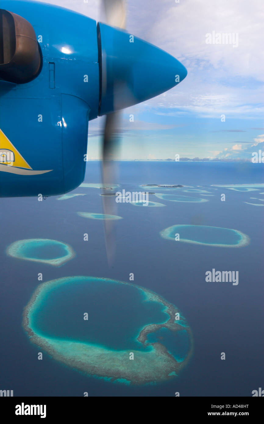 Aeroplane flies over the reefs of the Maldives, Asia Stock Photo