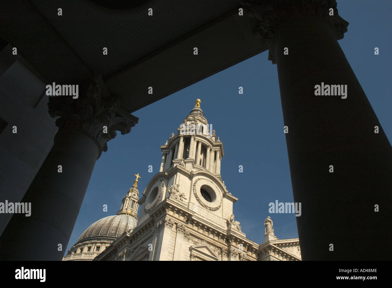 St Paul's Cathedral viewed between columns and roof in Paternoster Square London UK Stock Photo