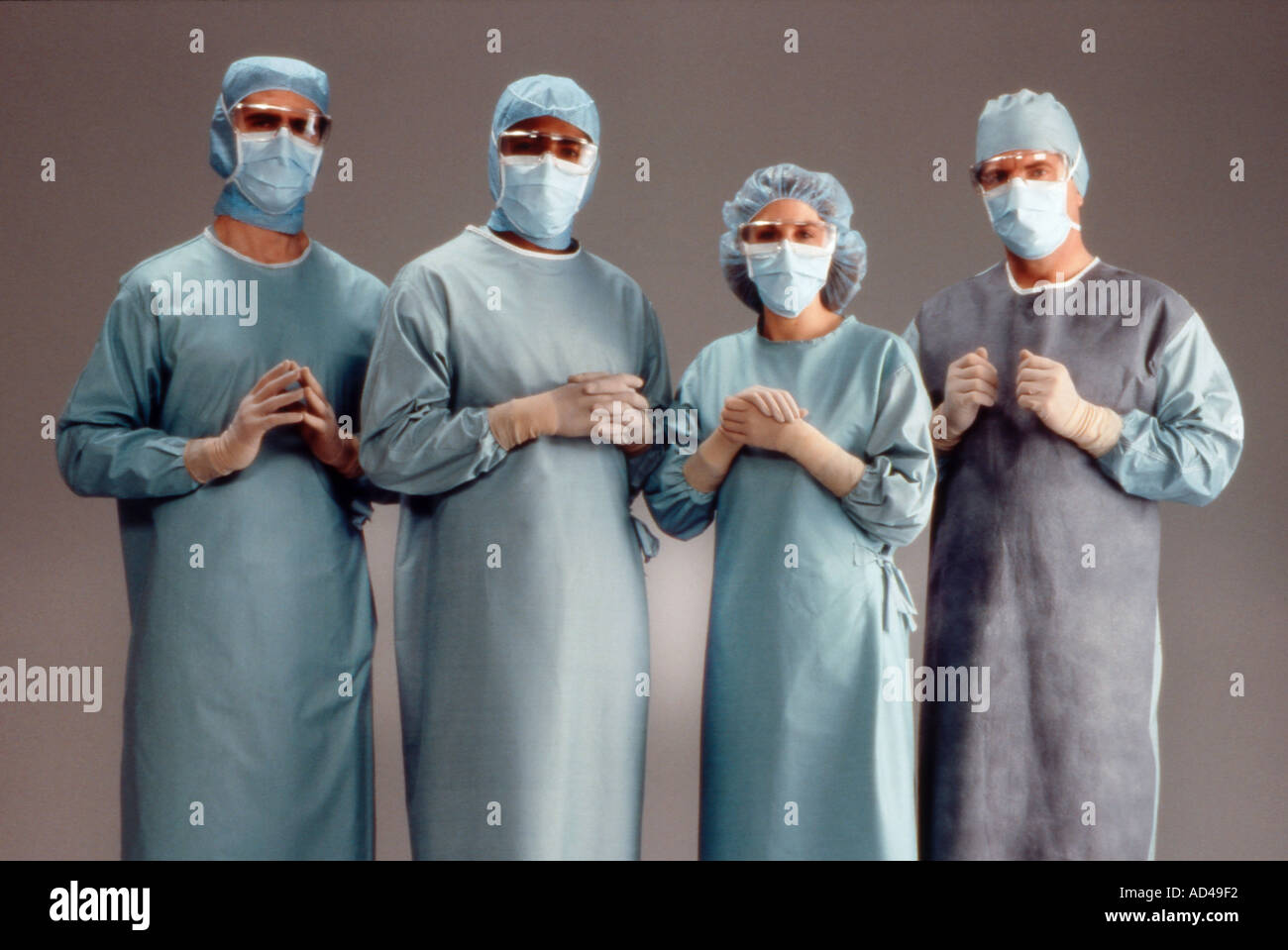 Surgeons in sterile masks gowns gloves hats Stock Photo Alamy