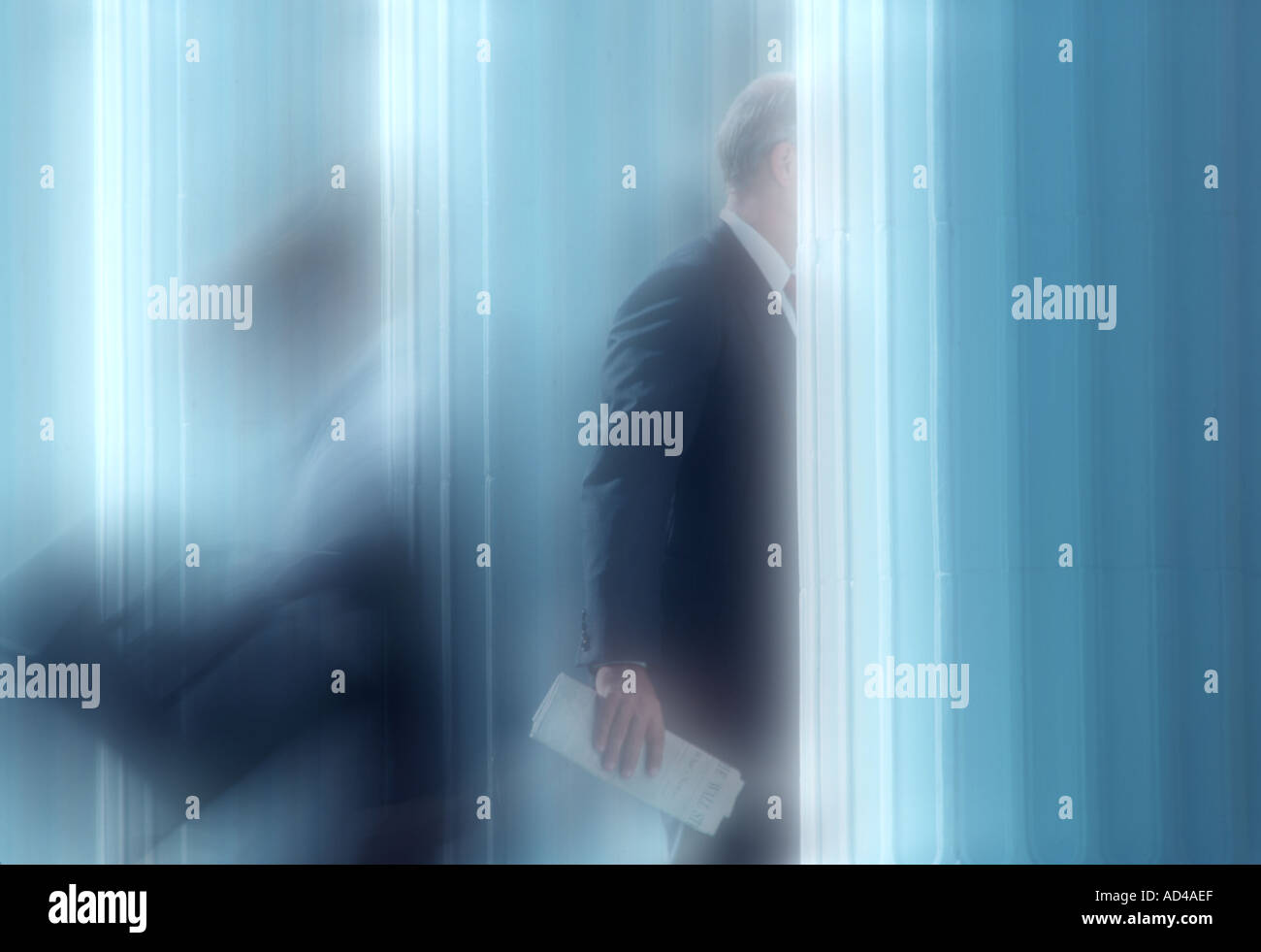 soft focus photo of business executives entering and leaving office building Stock Photo