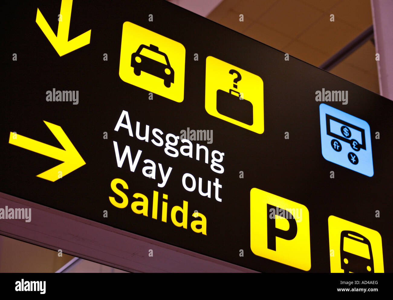Multilingual airport sign, directions to way out, Malaga, Spain Stock Photo