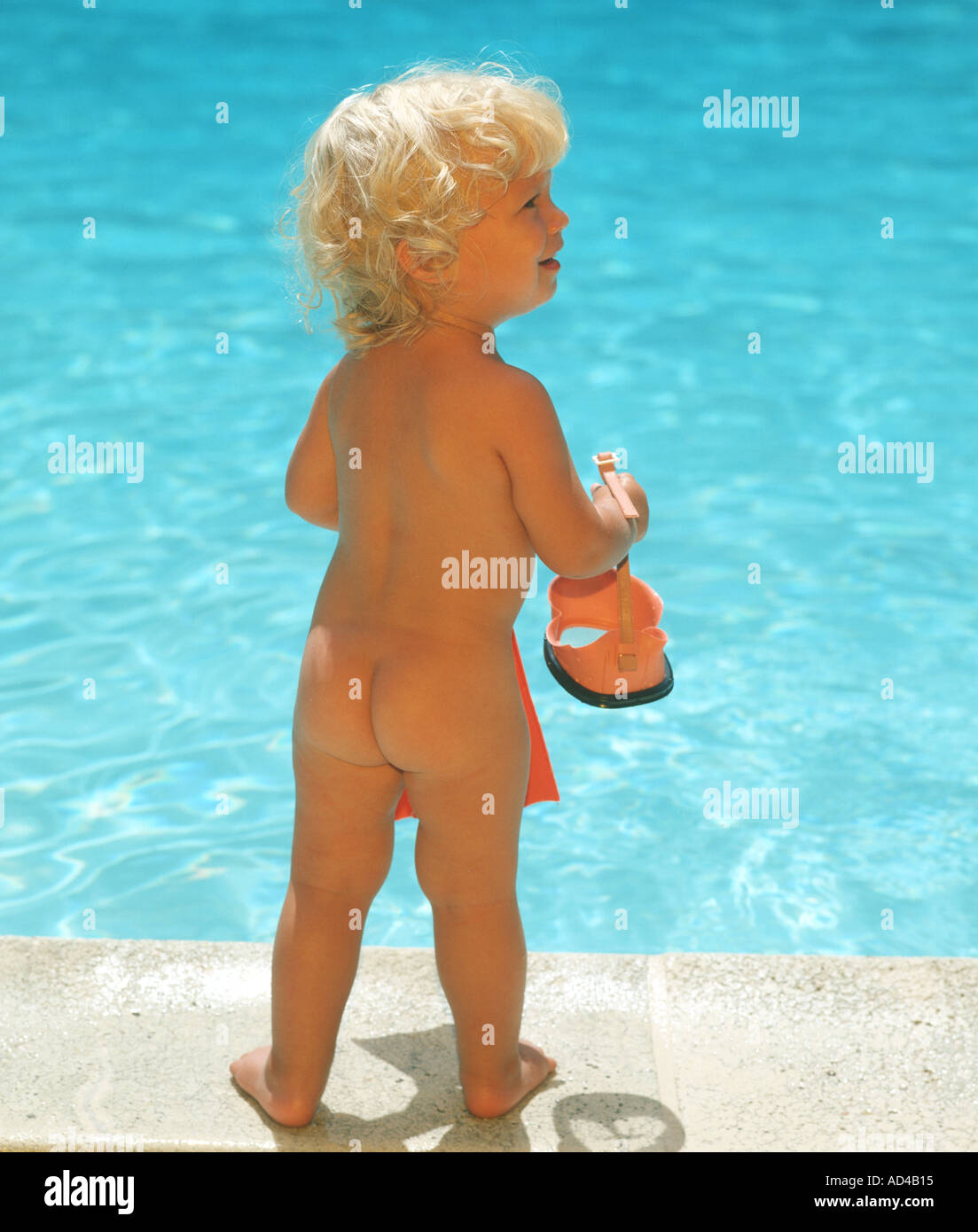baby girl by swimming pool in birthday suit Stock Photo