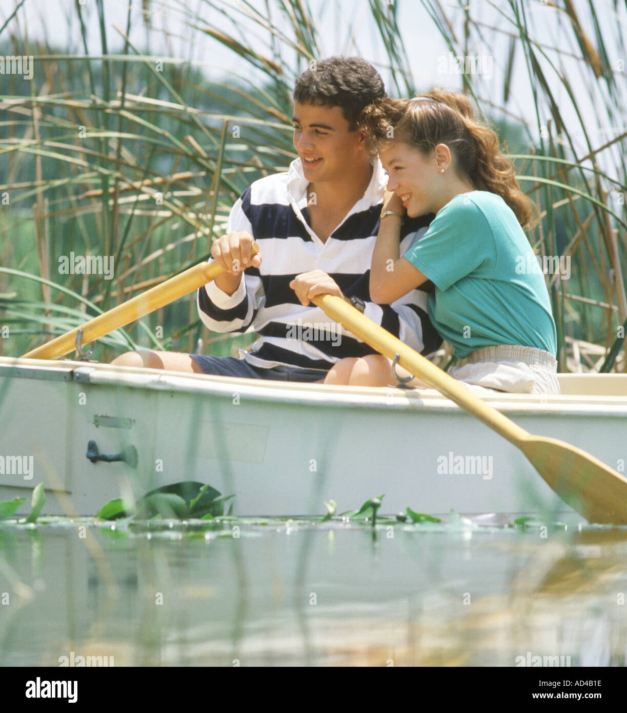 teenage couple relaxing in rowboat Stock Photo