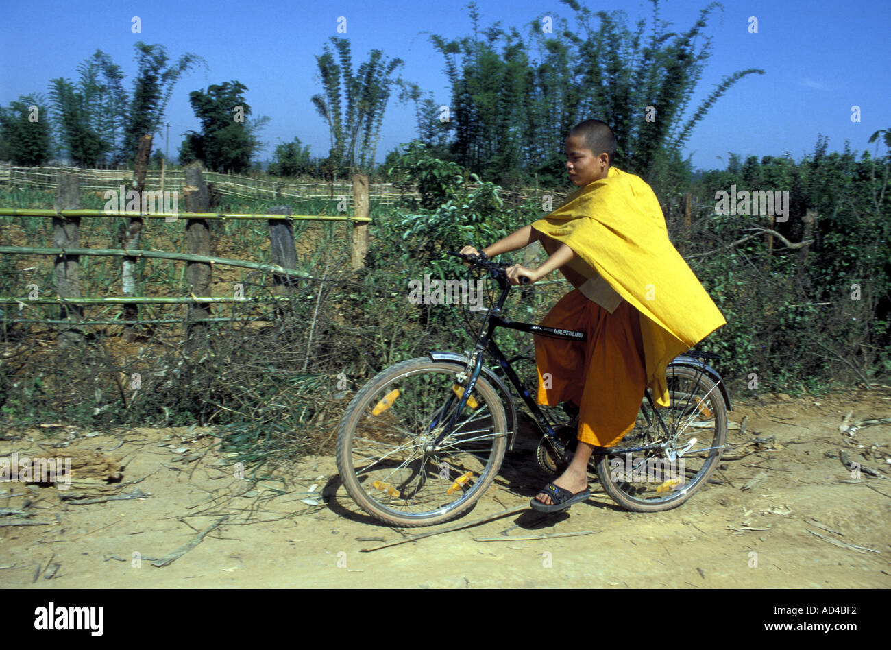 CHINA BUDDHIST MONK ON BICYCLE YUNNAN PROVINCE Stock Photo - Alamy