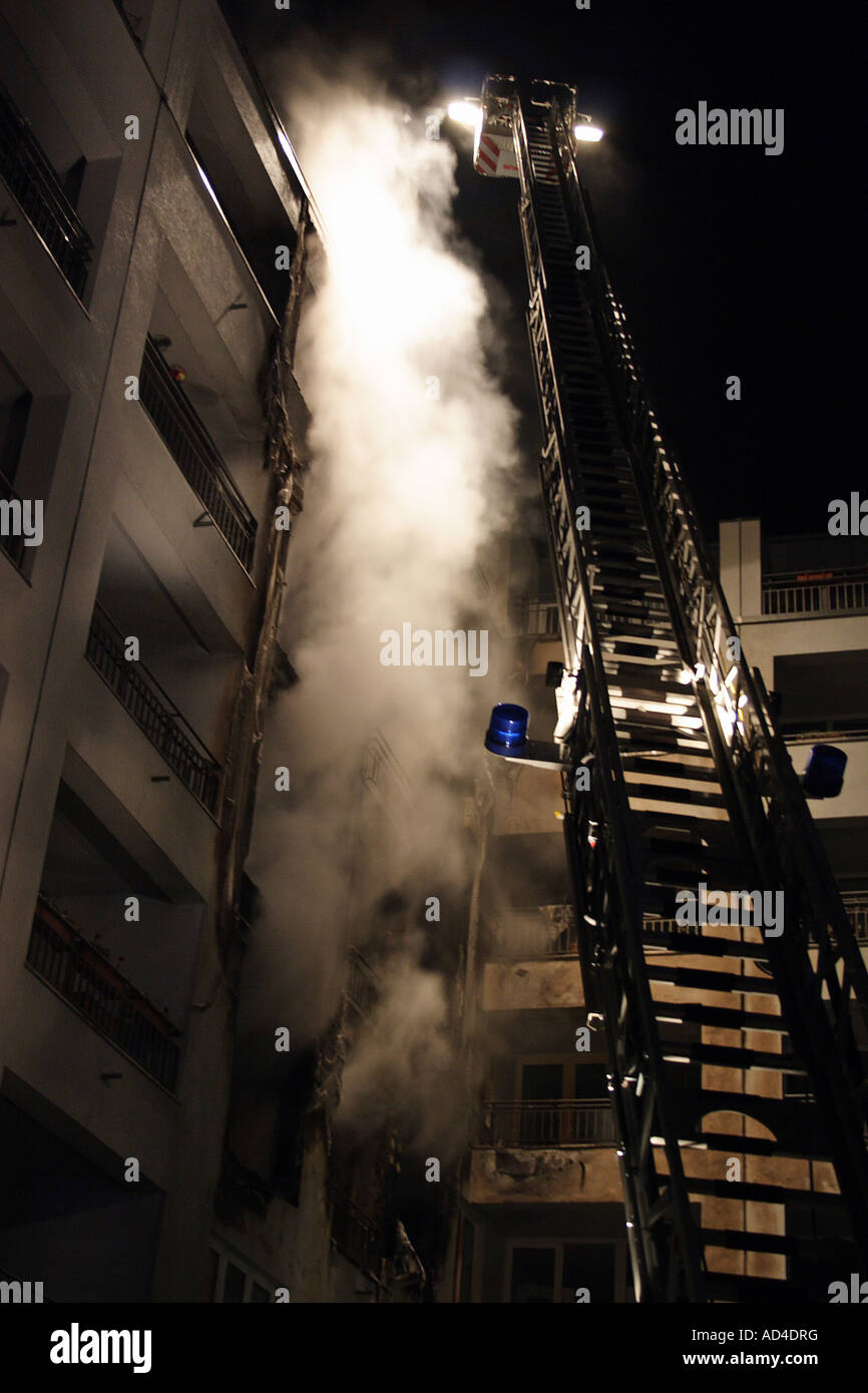 Fire extinguishing, burning apartment house Stock Photo
