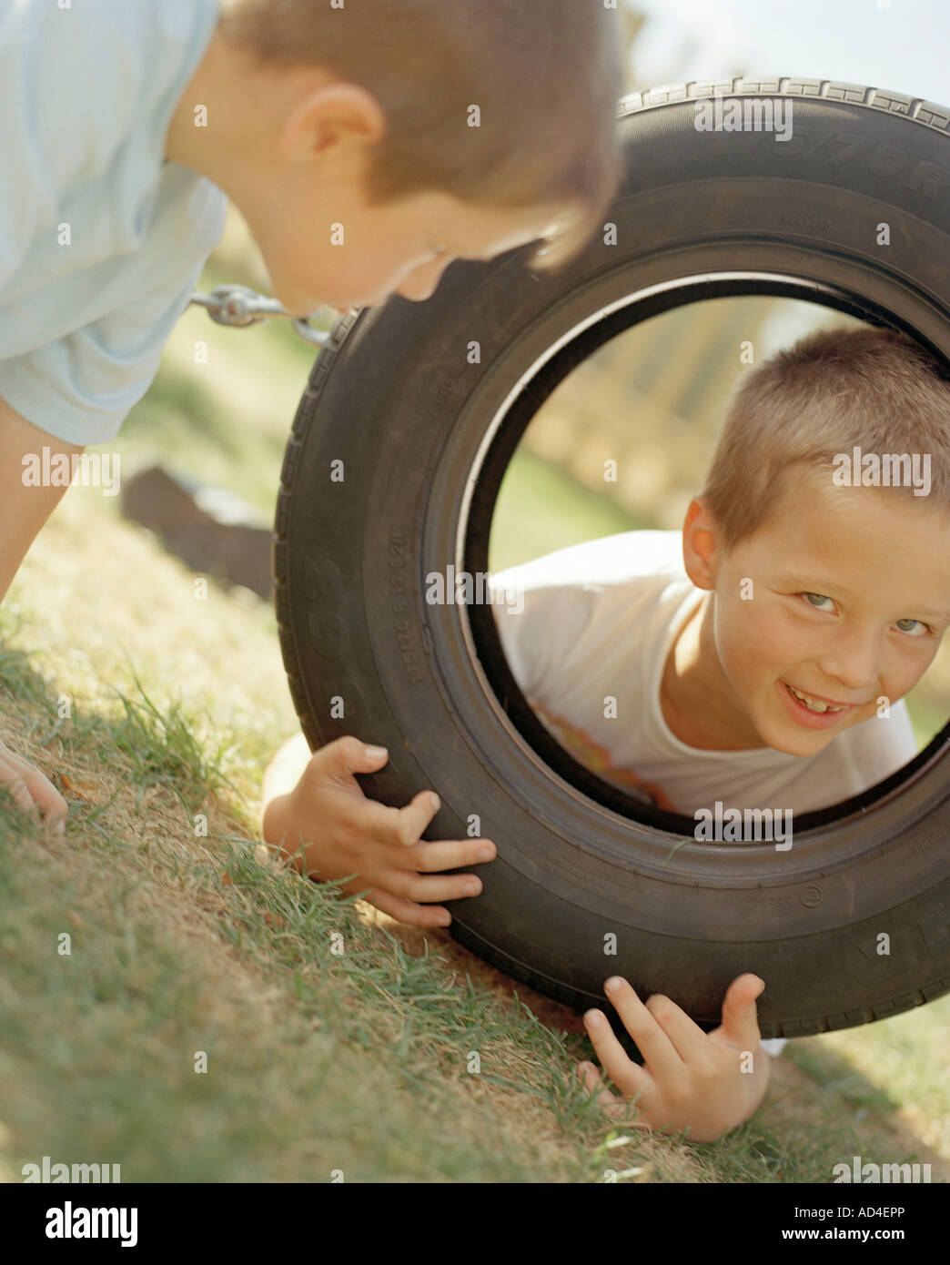Children playing with tire Stock Photo Alamy