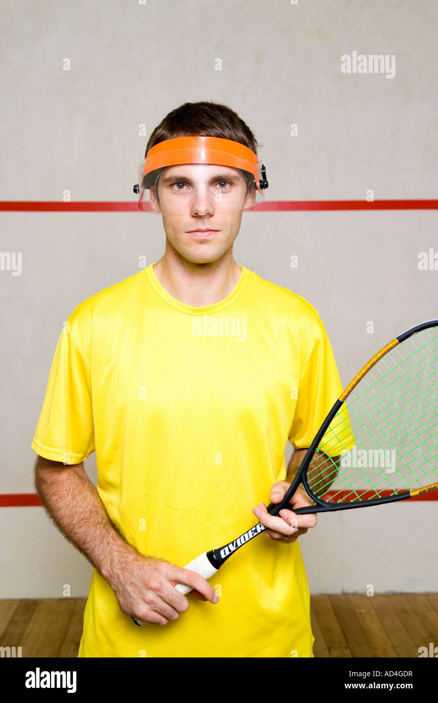 Portrait of a man wearing a visor and holding a squash racquet Stock Photo