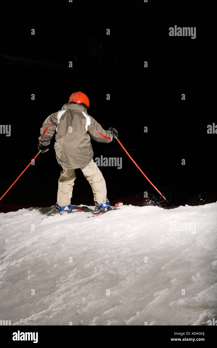 Rear view of a boy skiing on a ski slope Stock Photo