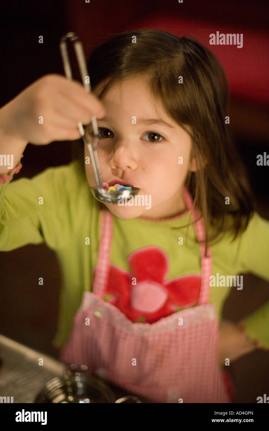 Young girl playing with a toy soup ladle Stock Photo Alamy