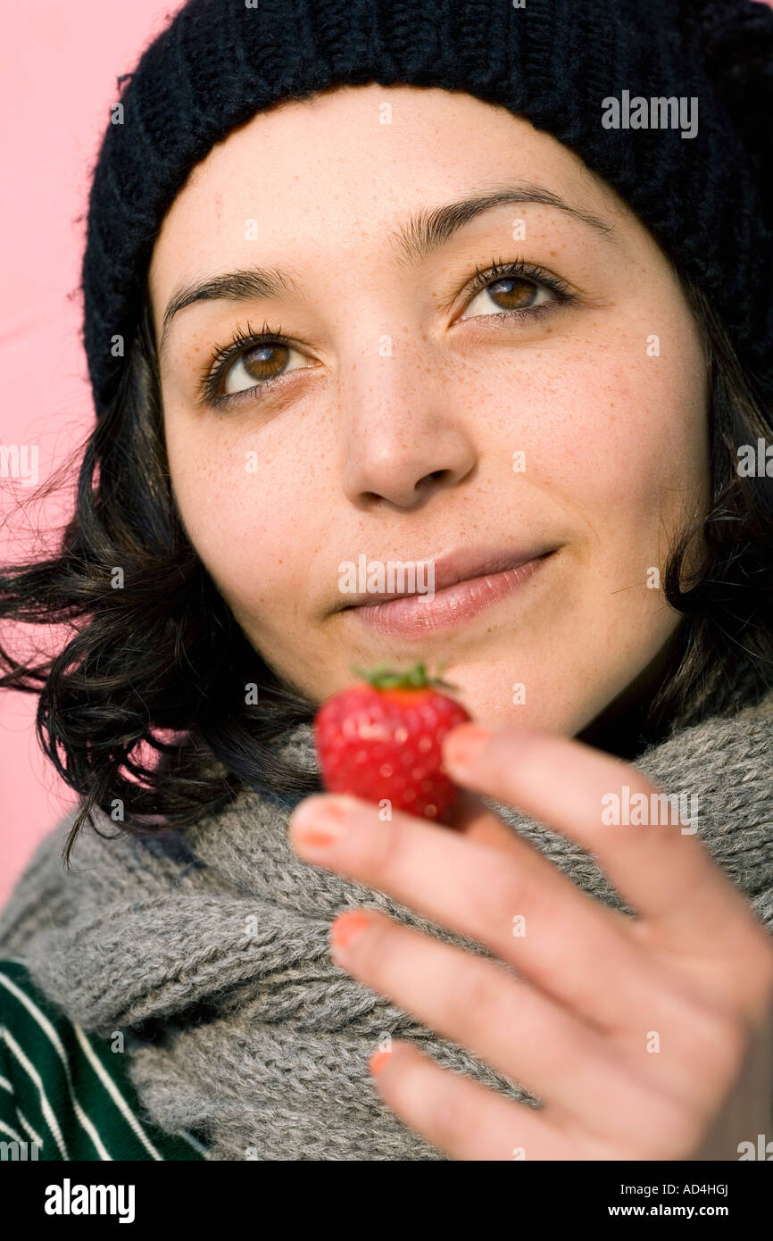 A woman holding a strawberry Stock Photo