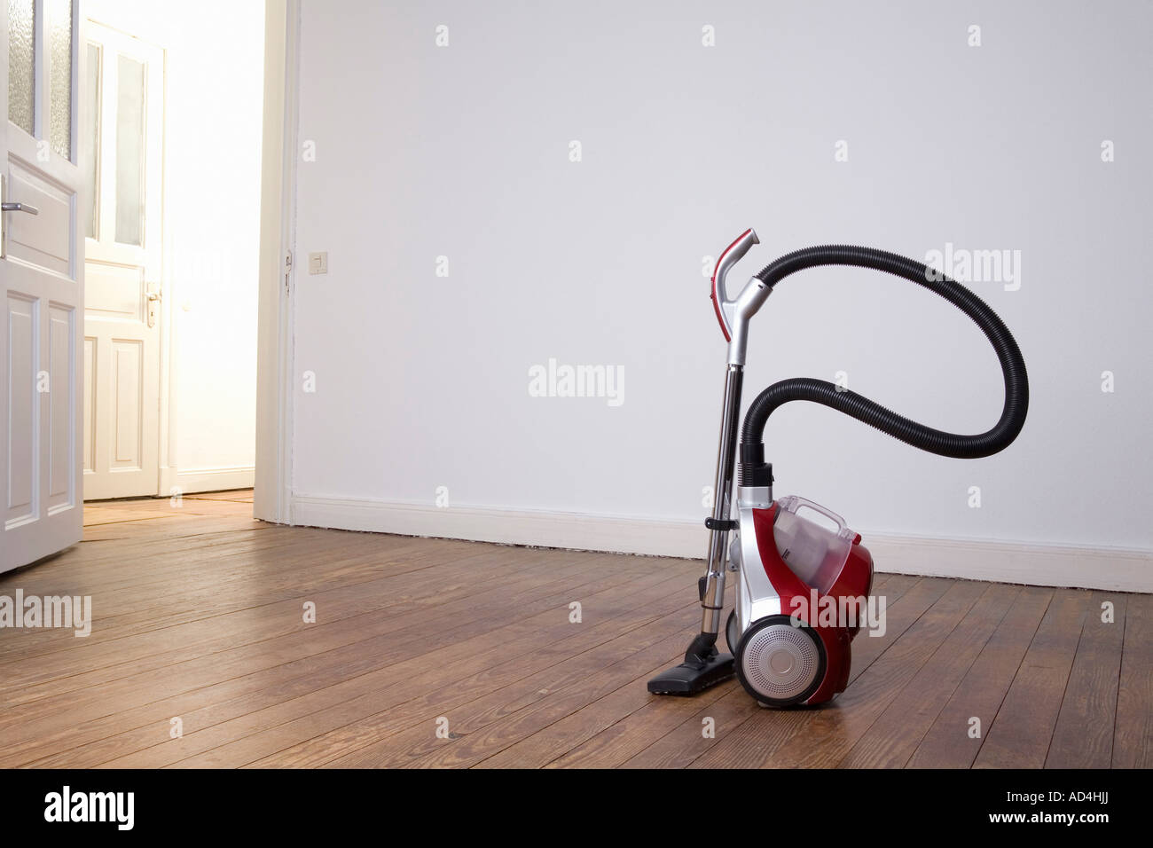Vacuum cleaner in an empty room Stock Photo