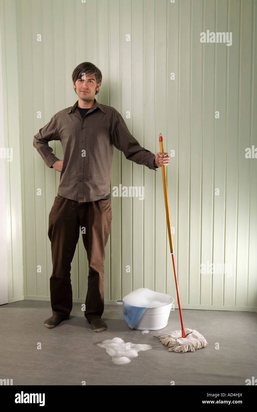 A man standing with a mop and bucket Stock Photo