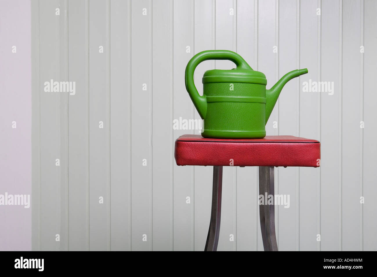A watering can on a stool Stock Photo