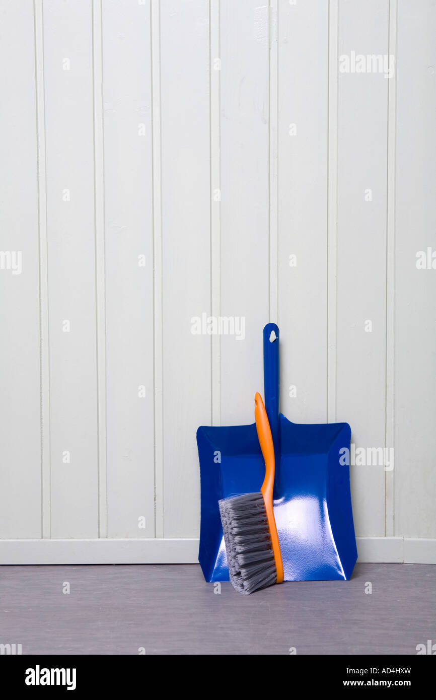 A dustpan and broom in a corner Stock Photo