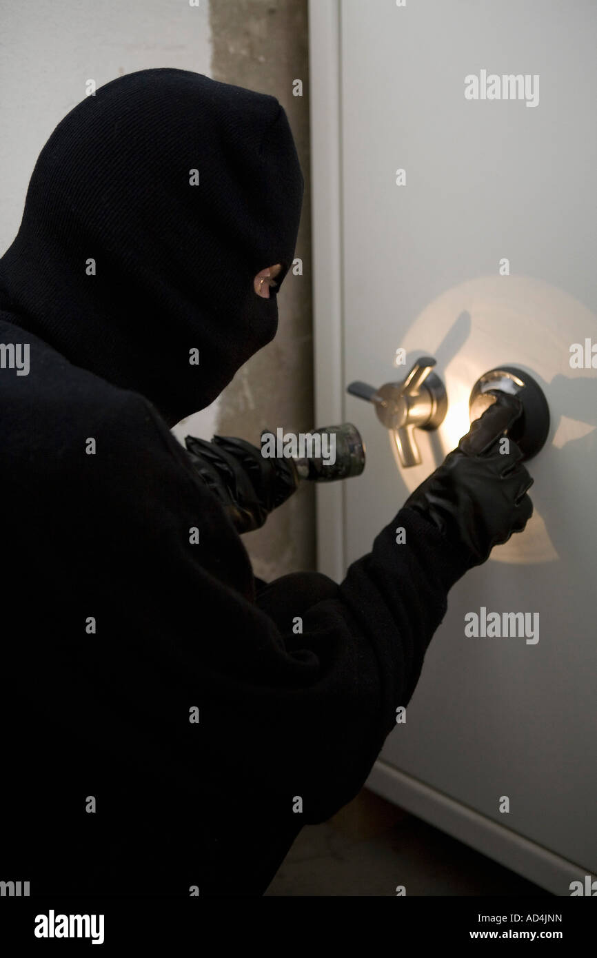 A thief unlocking a combination safe Stock Photo Alamy