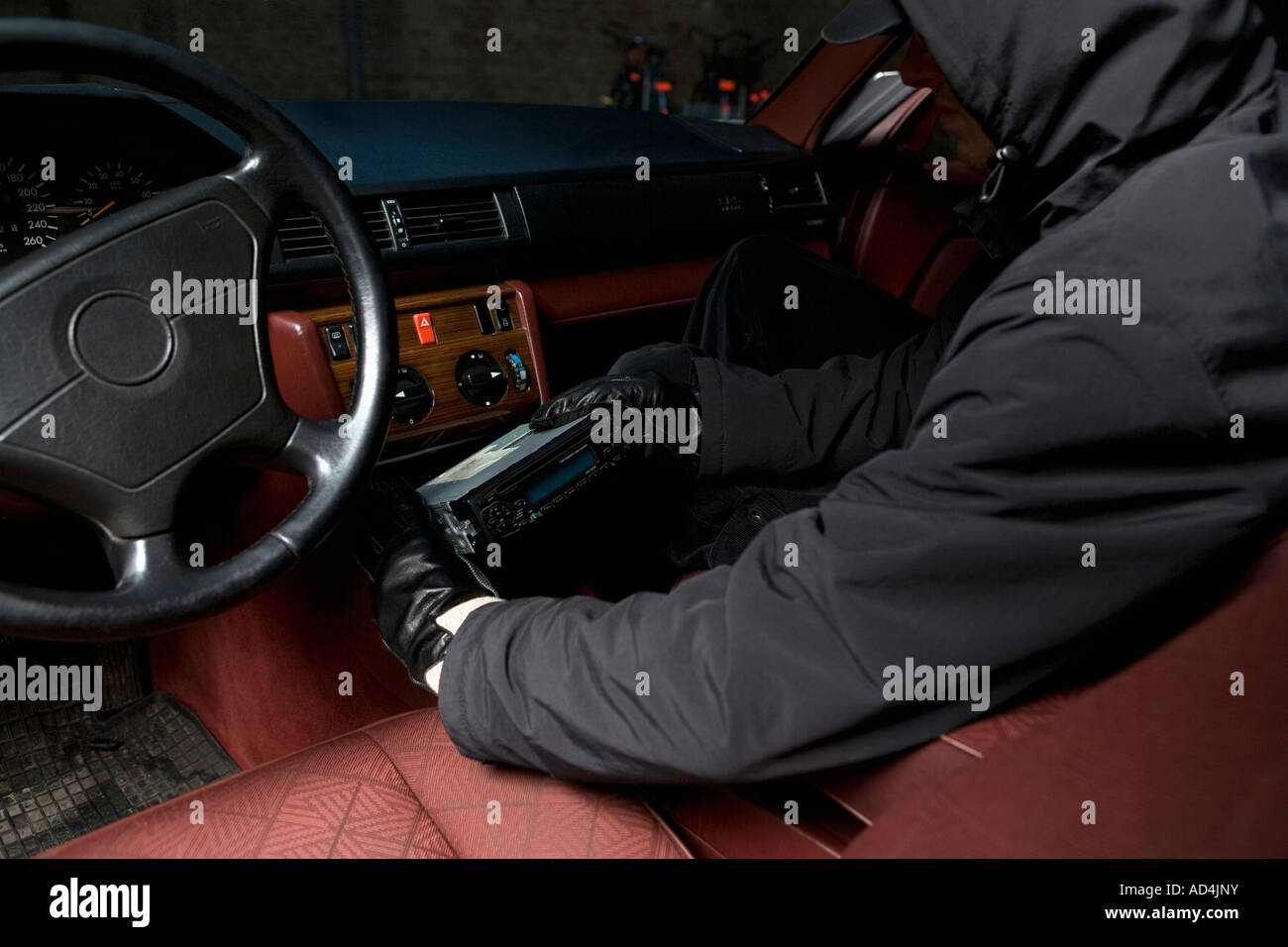A thief stealing a car stereo Stock Photo Alamy