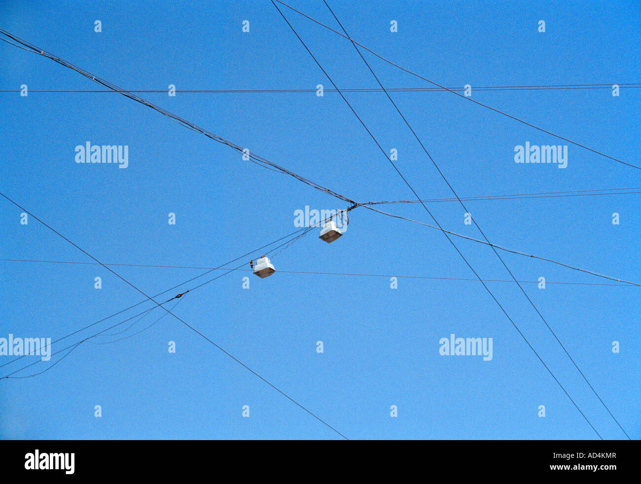 Power lines against a blue sky Stock Photo - Alamy