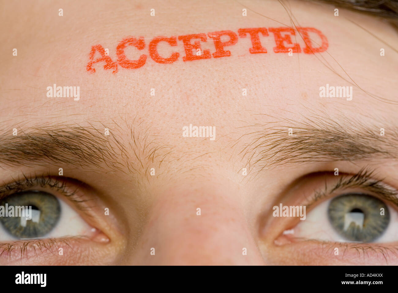 A man with 'Accepted' stamped on his forehead Stock Photo