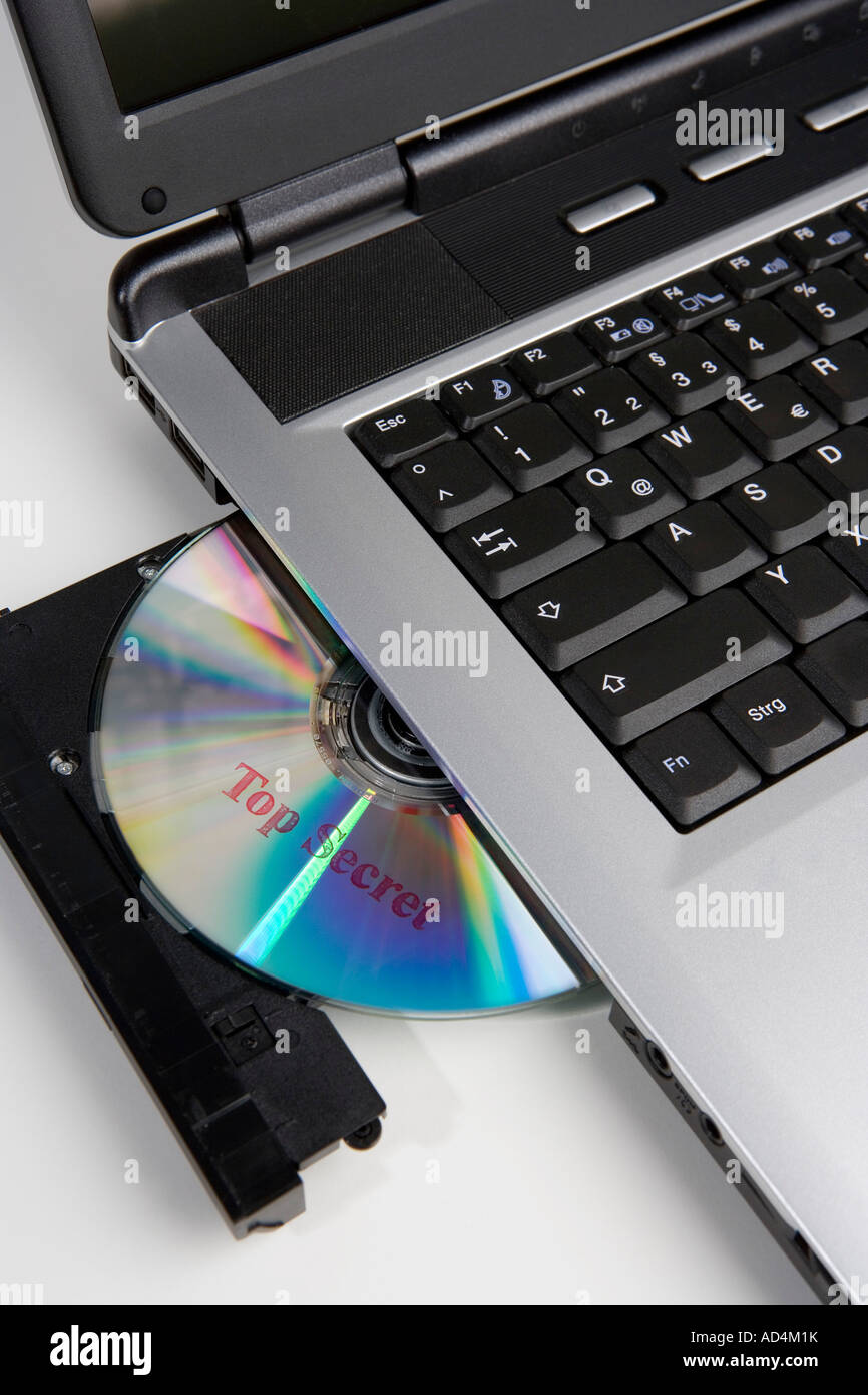 A CD stamped 'Top Secret' in the disc drive of a laptop computer Stock  Photo - Alamy