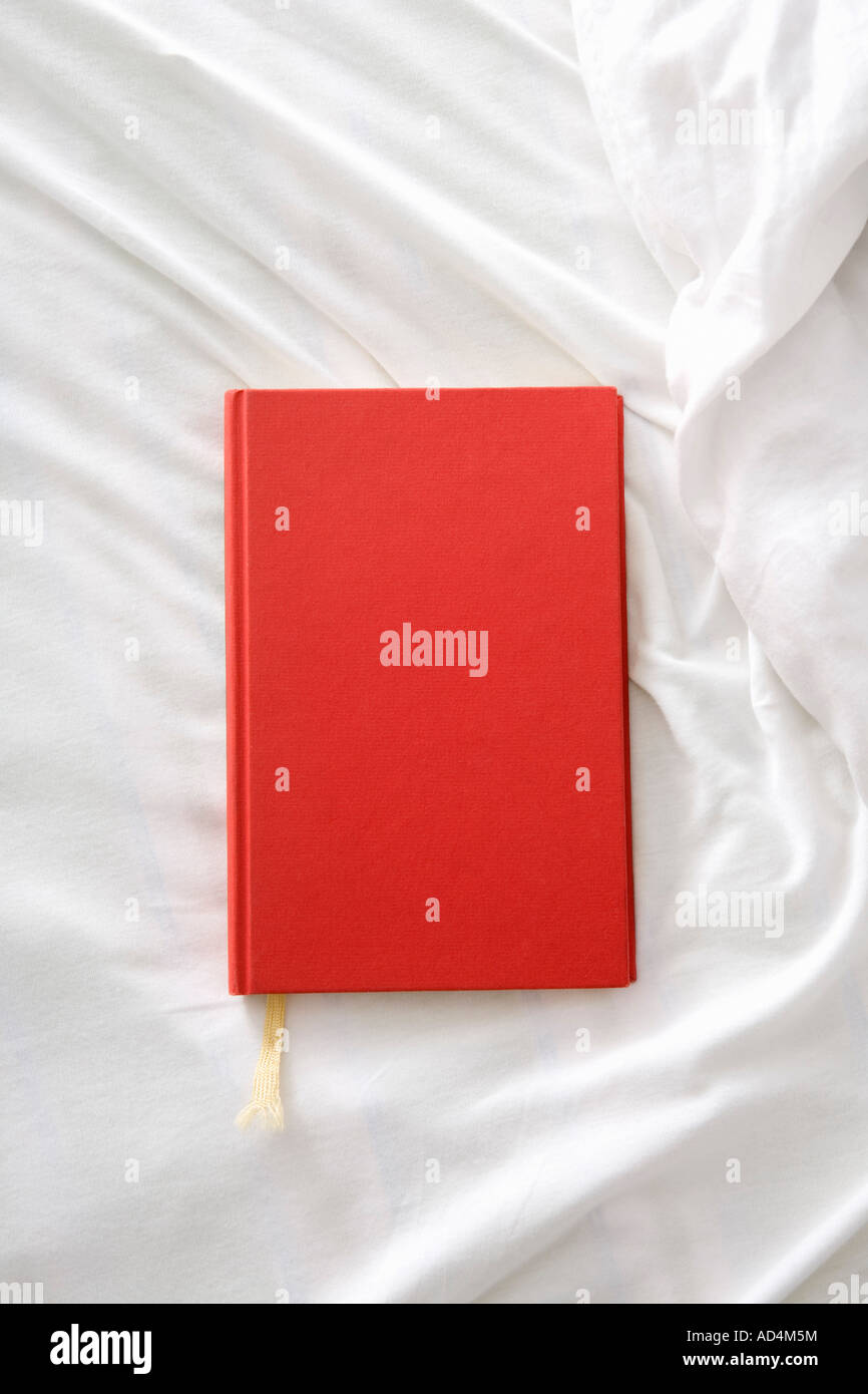A red book on a white sheet Stock Photo