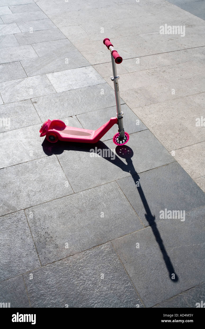 A pink scooter on the pavement Stock Photo Alamy